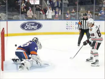  ?? Associated Press ?? Chicago’s Patrick Kane scores the winning goal on Islanders goaltender Semyon Varlamov in a shootout Sunday night.