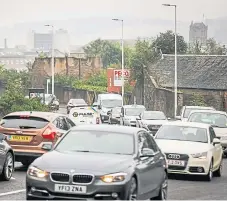  ??  ?? Busy traffic on Lochee Road, which has been found in the past to be one of the most polluted roads in Scotland.