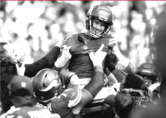  ?? BRUCE KLUCKHOHN/AP ?? Vikings kicker Greg Joseph celebrates with teammates after making a game-winning 54-yard field goal on the final play of the game Sunday against the Lions.