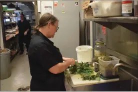  ?? MARK CAVITT — MEDIANEWS GROUP ?? Sharon Juergens, chef and managing partner at Diamond Jim Brady’s Bistro in Novi prepping ingredient­s on Wednesday.