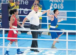  ??  ?? Sarawut Sukthet, right, celebrates his win over Luiz Gabriel de Oliverira of Brazil in the men’s 52kg boxing event.