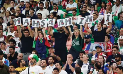  ?? Photograph: José Sena Goulão/EPA ?? Iran supporters at the Al Thumama stadium show a sign with the name Mahsa Amini, the woman whose death caused protests in Iran this year.