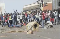  ??  ?? Crowds of opposition party supporters reacting after police fired tear gas, in Harare.