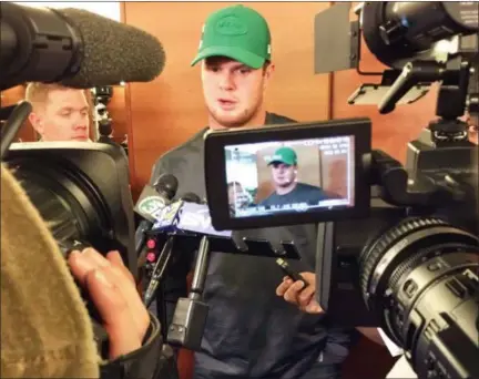  ?? DENNIS WASZAK JR. - THE ASSOCIATED PRESS ?? New York Jets quarterbac­k Sam Darnold talks with the media in the locker room in Florham Park, N.J. Darnold has a boot on his right foot and is not practicing, leaving his status for the team’s game against Buffalo on Sunday in doubt. Darnold was injured during the Jets’ 13-6 loss at Miami last Sunday, but finished the game.