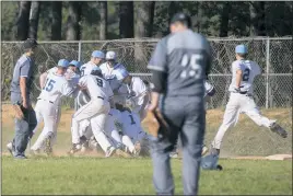  ?? PHOTO BY ROB WORMAN ?? La Plata’s baseball team celebrates after Matt Schnoor’s RBI single in the bottom of the seventh lifted the Warriors to a 5-4 win over the visiting Patuxent Panthers on Tuesday afternoon in the Class 2A South Region Section I final.