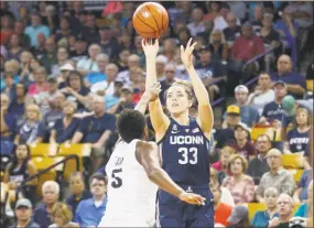  ?? Reinhold Matay / Associated Press ?? UConn’s Katie Lou Samuelson shoots over Central Florida forward Masseny Kaba on Sunday in Orlando, Fla. The Huskies won, 78-41.