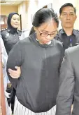  ??  ?? Chong being led out of the court after she was sentenced by the Sessions Court yesterday.