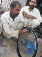 ??  ?? The facilities are basic, but this Pakistani wheel repairer knew what he was doing.