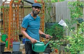  ?? AP PHOTO/LEKAN OYEKANMI ?? Marcus Bridgewate­r, a TikTok user who posts gardening videos, poses for a portrait Thursday at his home in Spring, Texas.