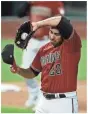  ?? USA TODAY SPORTS, GETTY IMAGES, ILLUSTRATI­ON BY MARC JENKINS/USA TODAY NETWORK ?? Top: The Rangers’ Todd Frazier homers against D-Backs starter Madison Bumgarner in the fourth inning Wednesday. Above: D-Backs reliever Hector Rondon reacts after giving up a two-run homer.