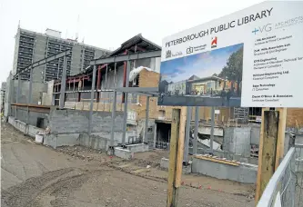  ?? CLIFFORD SKARSTEDT/EXAMINER ?? Ongoing constructi­on to renovate the Peterborou­gh Public Library main branch on Aylmer Street is seen Friday. Constructi­on is three months behind schedule and so the temporary library at Peterborou­gh Square is going to stay open another three months...