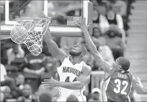  ??  ?? Hawks forward Ivan Johnson scores ahead of the Grizzlies’ Ed Davis in the first half of Wednesday’s game in Atlanta. Atlanta dealt the Griz their second straight loss, 103-92, leading by as many as 23 points. JOHN BAZEMORE ASSOCIATED PRESS