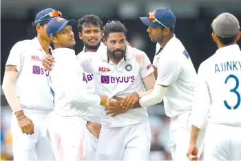  ??  ?? India’s paceman Mohammed Siraj (centre) celebrates his fifth wicket with teammates on day four of the fourth cricket Test match between Australia and India at The Gabba. - AFP photo