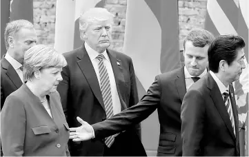  ??  ?? (From left) European Council president Donald Tusk, German Chancellor Angela Merkel, US President Donald Trump, French President Emmanuel Macron and Japanese Prime Minister Shinzo Abe walk after a family photo during the G7 Summit in Taormina, Sicily, Italy. — Reuters photo