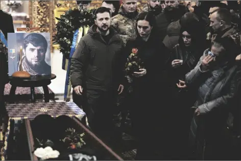  ?? THIBAULT CAMUS/AP ?? UKRAINIAN PRESIDENT VOLODYMYR ZELENSKYY and Finland’s Prime Minister Sanna Marin attend the funeral of Ukrainian officer Dmytro Kotsiubayl­o, code-name “Da Vinci”, at the St. Michael’s Cathedral, in Kyiv, Ukraine, on Friday. Kotsiubayl­o was killed in a battle near Bakhmut in the Donetsk region three days ago.