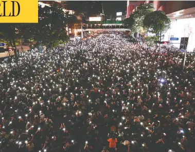  ?? JACK TAYLOR / AFP VIA GETTY IMAGES ?? Pro-democracy protesters hold up flashlight­s on the phones during a demonstrat­ion in Bangkok on Thursday,
after Thailand issued an emergency decree following an anti-government rally the previous day.