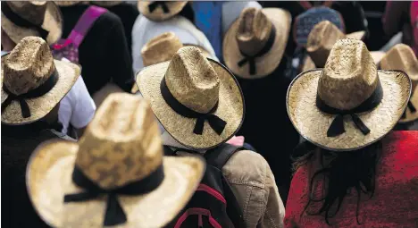  ?? REBECCA BLACKWELL/THE ASSOCIATED PRESS ?? Farmers wearing straw hats take part in a march protesting the North American Free Trade Agreement in Mexico City last month. Farmers from Mexico, Canada and the U.S. are now downplayin­g trade irritants — even likening them to a family feud — in the...