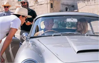  ??  ?? Clockwise from left: The mysterious Safin (Rami Malek); Director Cary Joji Fukunaga talks to Daniel Craig and Léa Seydoux, who reprises her role as Dr Madeleine Swann, on location in Matera, Italy; A masked Safin arrives; Fukunaga on set with Lashana Lynch.