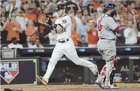  ?? AP PHOTO ?? ONE DOWN: Catcher Sandy Leon looks away as Josh Reddick scores a run during the Sox’ loss to the Astros in Game 1 of the ALDS yesterday in Houston.