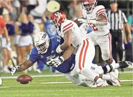  ?? SUE OGROCKI/AP ?? Tulsa offensive lineman Tyler Smith (56) dives on the ball to recover a fumble in front of Houston linebacker Deontay Anderson (2) on Oct. 1 in Tulsa.