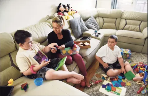  ?? Tyler Sizemore / Hearst Connecticu­t Media ?? Timea Zadori cares for her two children, Noah, left, 9, and Noel, 10, at her apartment in Greenwich on April 21. Zadori quit her job during the pandemic to care for her two nonverbal sons on the autism spectrum who require constant attention and assistance.