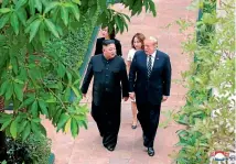  ?? AP ?? US President Donald Trump and North Korean leader Kim Jong Un walk together during their meeting at a hotel in Hanoi, Vietnam.