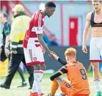  ??  ?? Rakish Bingham consoles United sriker Simon Murray after the play-off game in 2017.