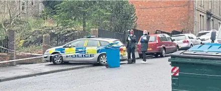  ??  ?? Police officers at the cordoned off scene of the “targeted attack” on Cleghorn Street.