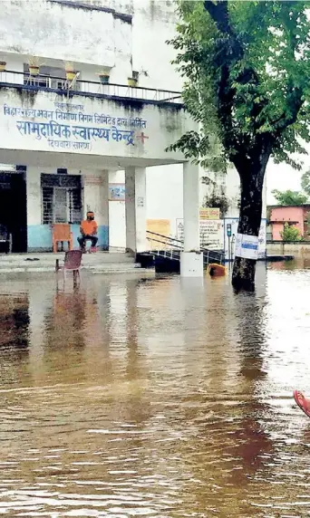  ?? ?? Still hope: People outside a flooded government health centre in Saran, Bihar in 2021.