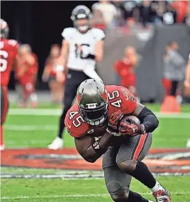  ?? AP ?? Tampa Bay Buccaneers linebacker Devin White intercepts a Jacksonvil­le Jaguars pass during the first half of Sunday’s game in Tampa, Fla.