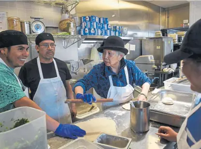  ?? Aaron Ontiveroz, The Denver Post ?? Anna Zoe, center, gives instructio­n to employees Jose Ruiz, left, Pepe Ordaz and Fatima Ordaz at the Zoe Ma Ma restaurant in Denver. Edwin Zoe, who owns the business with his mother, Anna, is a passionate supporter of paid family leave. About 19% of U.S. workers had a paid leave benefit last year, up from just 10% in 2010.