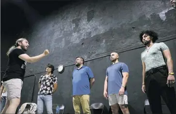  ?? Photograph­s by David Maung For the San Diego Union-Tribune ?? VOCAL COACH Israel Rodriguez, left, conducts a rehearsal of the Tijuana Gay Men’s Chorus. The group is working to raise the profile of the LGBTQ community at a time when there have been advances and setbacks.