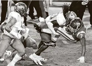  ?? Keith Birmingham / Associated Press ?? Oregon safety Jamal Hill tackles USC running back Stephen Carr after Carr converted a first down at Los Angeles Memorial Coliseum. It was the Ducks’ second straight Pac-12 title.