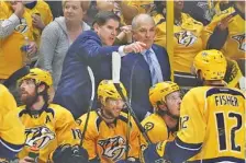  ??  ?? Coach Peter Laviolette, top left, talks with assistant coach Kevin McCarthy during the Nashville Predators’ home win against St. Louis this past Sunday. The victory clinched the second-round series in six games and sent the franchise to the conference...