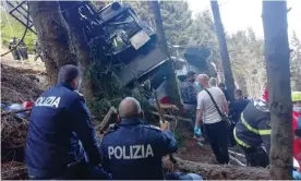  ?? Stresa, near Lake Maggiore, Italy. Photograph: Italian police/Reuters ?? Police and rescue service members are seen near the crashed cable car after it collapsed in
