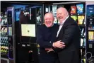  ?? Joel Goodman/The Guardian ?? John Broderick Sr (left) and his son Johnny in the warehouse of their vending machine business in Manchester. Photograph: