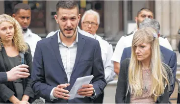  ?? Matt Dunham / Associated Press ?? Chris Gard, father of critically ill baby Charlie Gard, finishes reading a statement flanked by mother Connie Yates, right, at the end of their case Monday at London’s High Court.