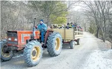  ?? BOB TYMCZYSZYN/POSTMEDIA NETWORK ?? Agape Sugar Bush visitors are shuttled aboard a hay wagon as the maple syrup operation opened for the first time this season on the weekend. Tours were available and pancakes and sausages along with maple syrup were served up Saturday.