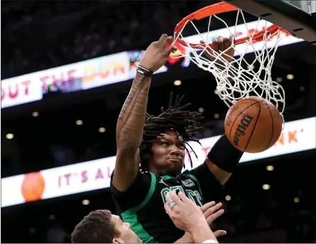  ?? NANCY LANE / HERALD STAFF FILE ?? OUT AGAIN: Robert Williams stuffs the ball over Milwaukee center Brook Lopez in Game 1. Knee soreness caused the Celtics’ big man to miss Monday night’s Game 4.