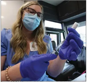  ?? (Arkansas Democrat-Gazette/Thomas Metthe) ?? Pharmacist Emily Sprick fills syringes with the Pfizer covid-19 vaccine Wednesday during a vaccinatio­n clinic at the River Cities Travel Center in downtown Little Rock. The state has opened vaccine eligibilit­y to all Arkansans age 16 and older, but some clinics are not seeing the huge surge of patients they had expected.