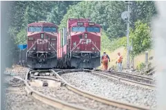  ??  ?? PATH TO SAFETY: Canadian Pacific Railway locomotive­s in the Fraser River Valley as wildfires burn near Lytton, British Columbia, Canada, on Friday.