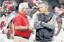  ?? BUTCH DILL/AP ?? Mike Smith, left, and Bucs head coach Dirk Koetter also had coached together in Jacksonvil­le and Atlanta — where Smith was Koetter’s boss — before working for Tampa Bay.