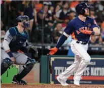 ?? Associated Press ?? n Houston Astros' Derek Fisher watches his two-run home run off Seattle Mariners starting pitcher Andrew Moore during the fifth inning of a baseball game Sunday in Houston.
