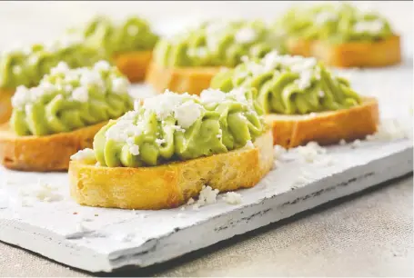  ?? PHOTOS: ATCO BLUE FLAME KITCHEN ?? Vary the heat in these tasty crostini appetizers, which feature avocado and feta, by using different peppers.