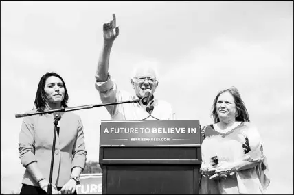  ??  ?? Sanders and his wife, Jane O’Meara Sanders, right, appear on stage after being introduced by Rep. Tulsi Gabbard, D-Hawaii,, left, at a March 2016 campaign rally at the University of Florida in Gainesvill­e, Fla. As the 2020 presidenti­al campaign approaches, Gabbard appears ready to abandon Sanders and launch a presidenti­al run on her own.