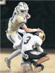  ??  ?? Heritage Hall’s Blake Adams tries to get by Broken Bow’s Kaleb Meeks during Friday’s game.