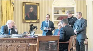  ?? Andrew Harnik Associated Press ?? OF TOP aides pictured in January, only Vice President Mike Pence remains. Gone are Chief of Staff Reince Priebus, center; national security advisor Mike Flynn, seated; spokesman Sean Spicer, right; and Bannon.