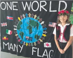  ??  ?? GOING GLOBAL: St Rita’s Babinda student Georgina Stone near the school’s Babinda Harvest Festival parade float.