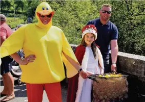  ??  ?? Going quackers Karen Kelly in duck outfit with event sponsor Scott Kirkland and Queen Rhian Crichton prior to releasing the ducks