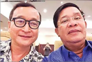  ?? SUPPLIED ?? Prime Minister Hun Sen and former opposition leader Sam Rainsy take a photo together during a dinner at the Hotel Cambodiana in 2015.